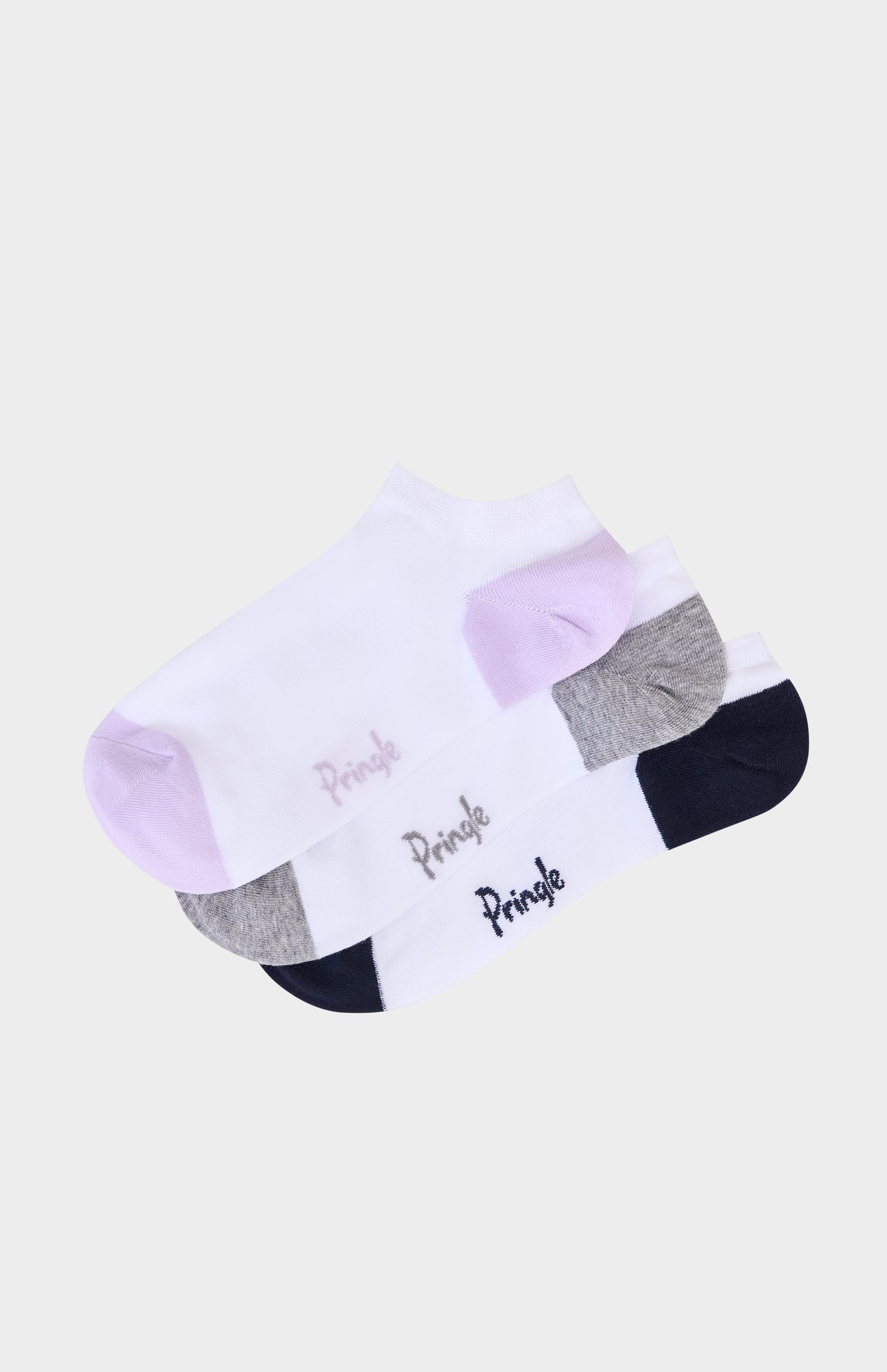 White socks with navy, grey, and purple accents and 'Pringle' branding on a beige background
