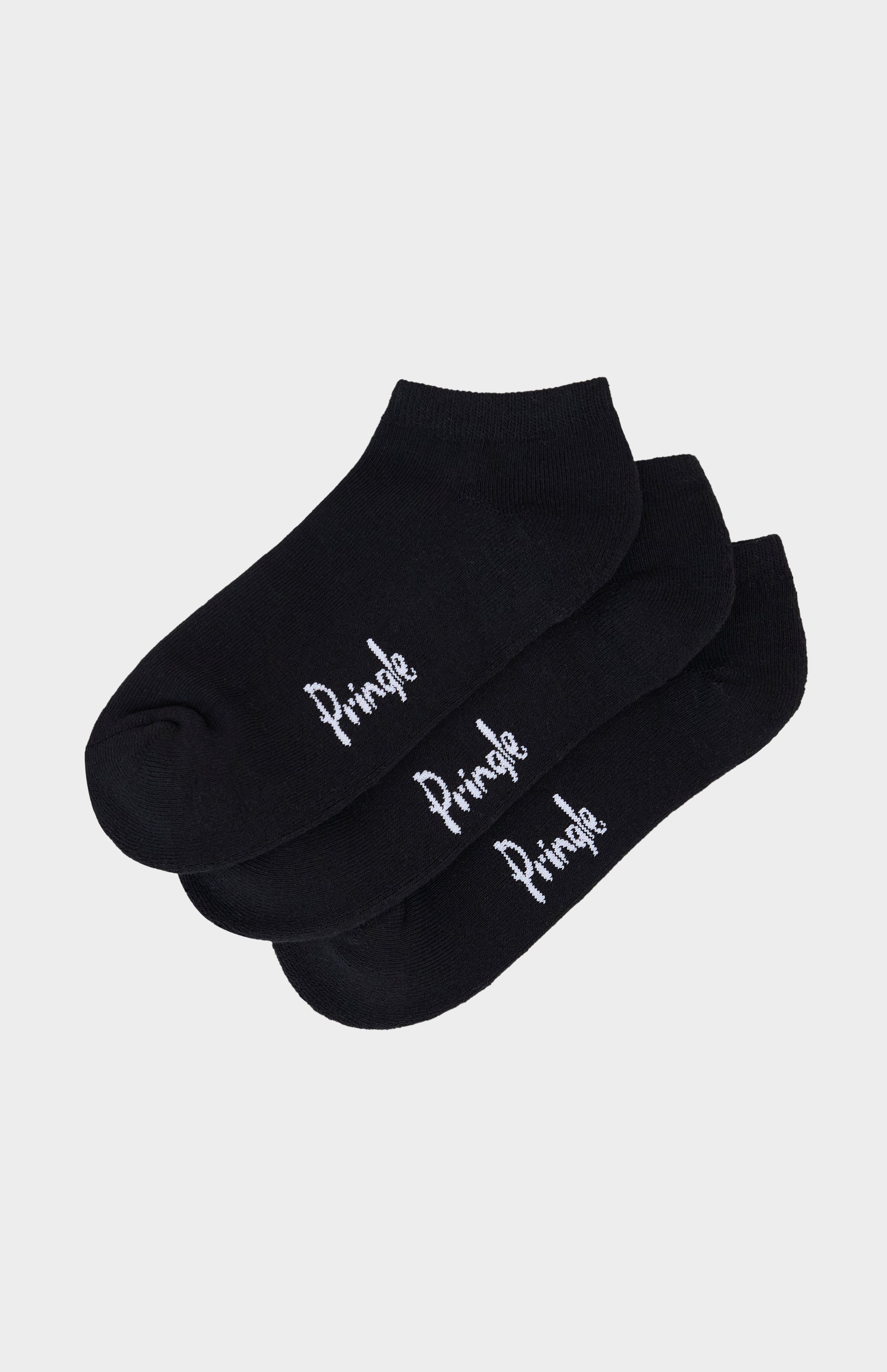 Black trainer socks with Pringle branding against light grey background