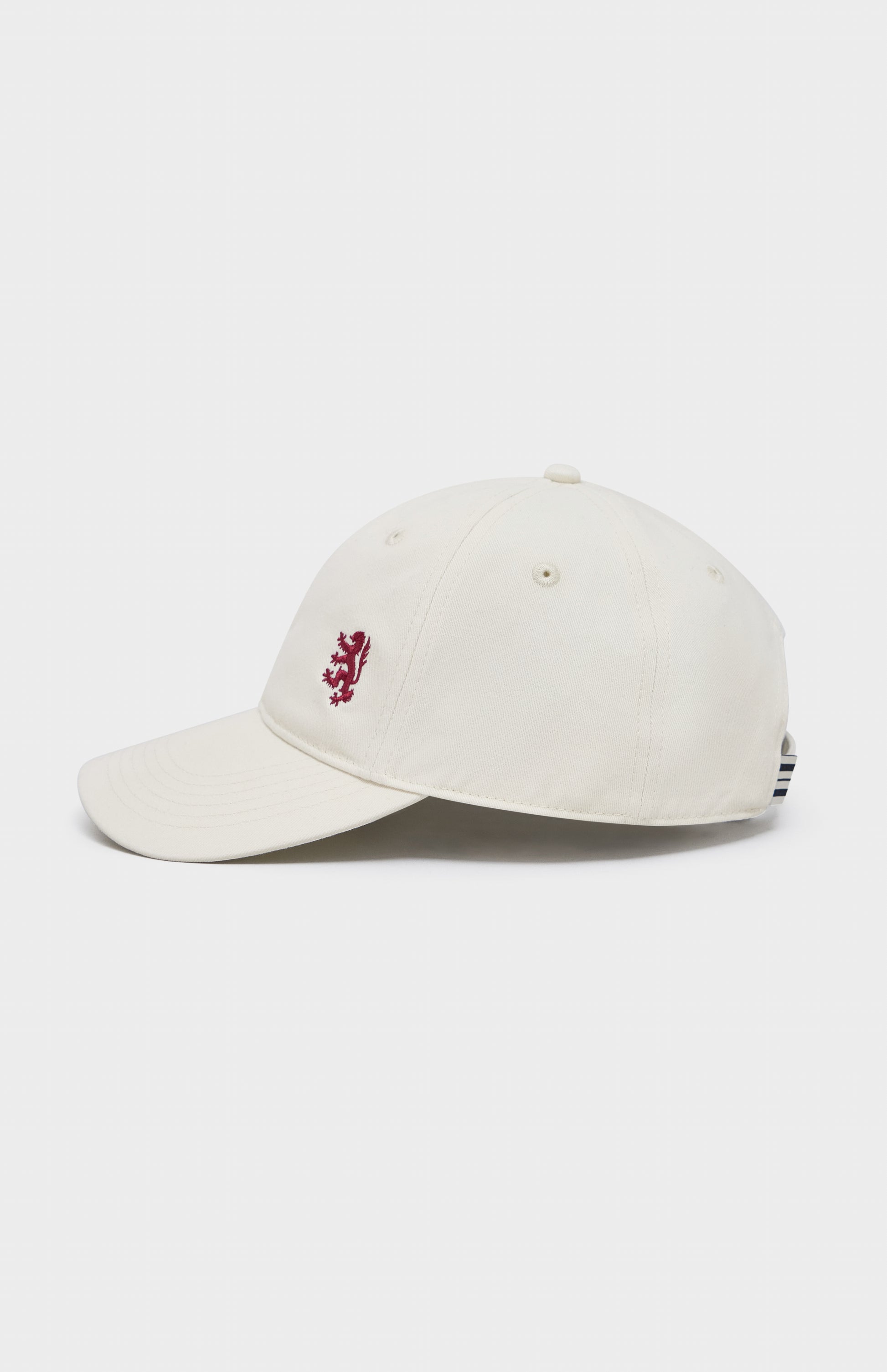 Ecru baseball cap with red lion embroidery on the right hand side