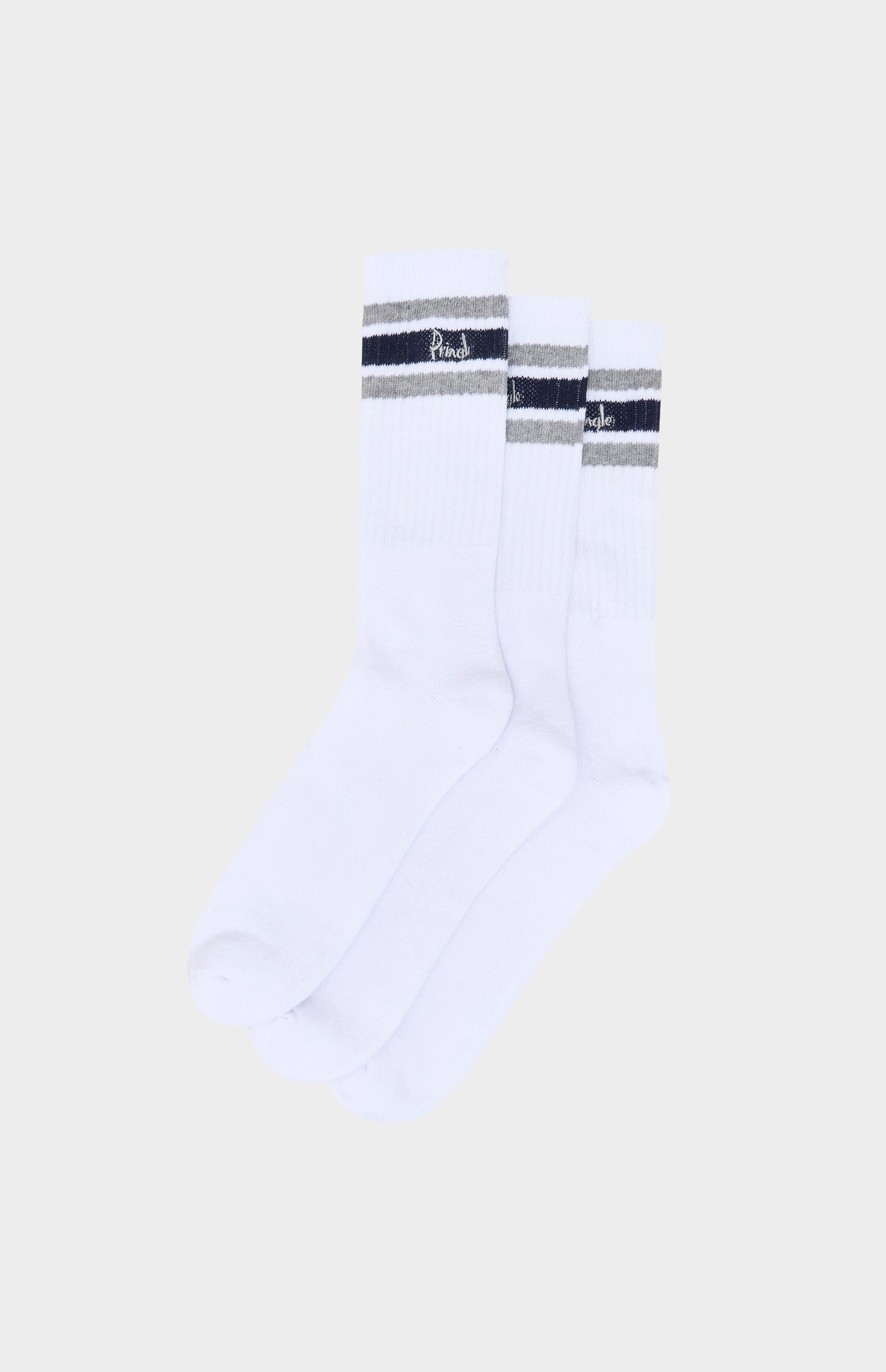White socks with black and gray striped accents on a beige background