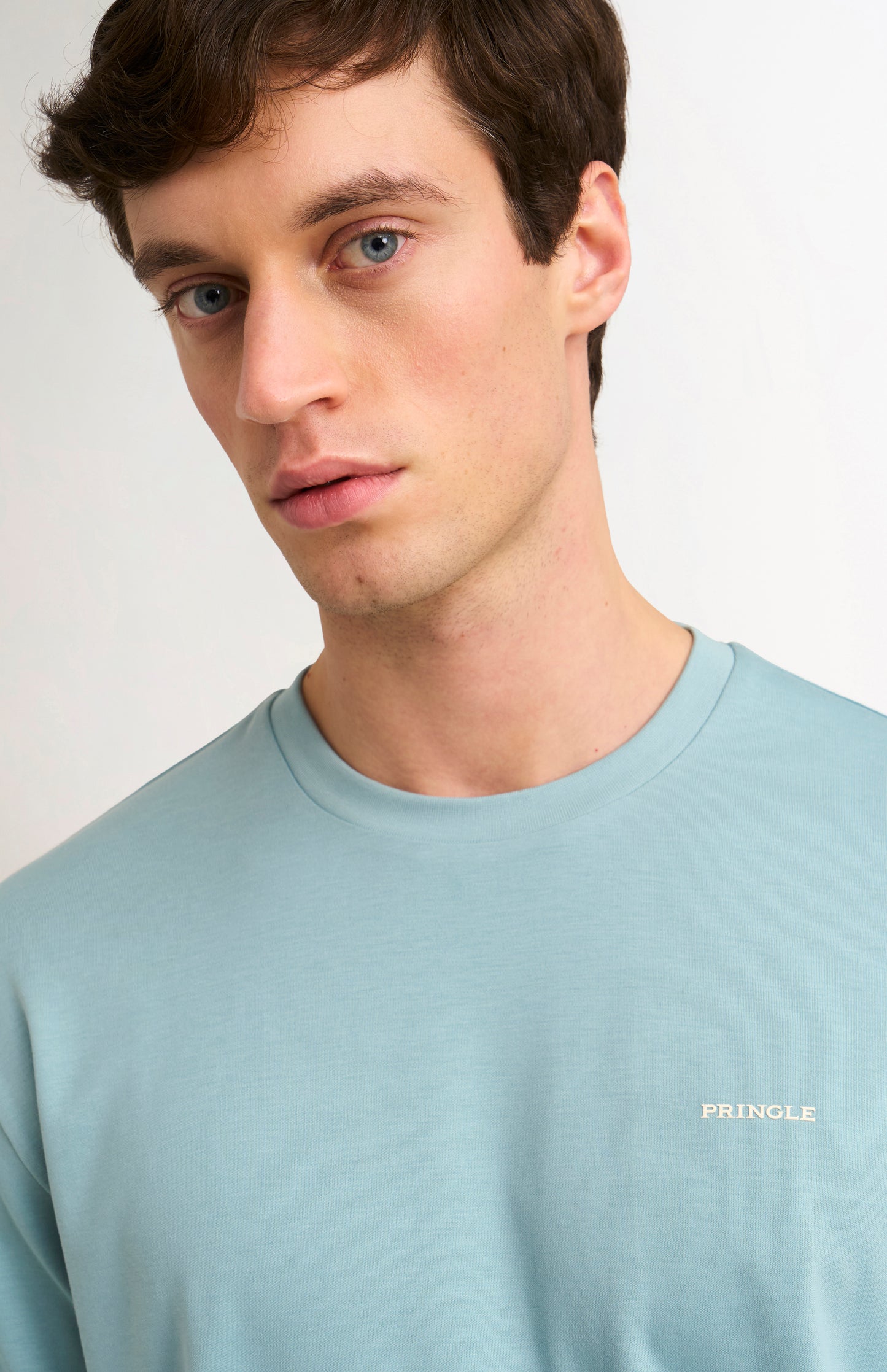 Man wearing a blue t-shirt on a white background