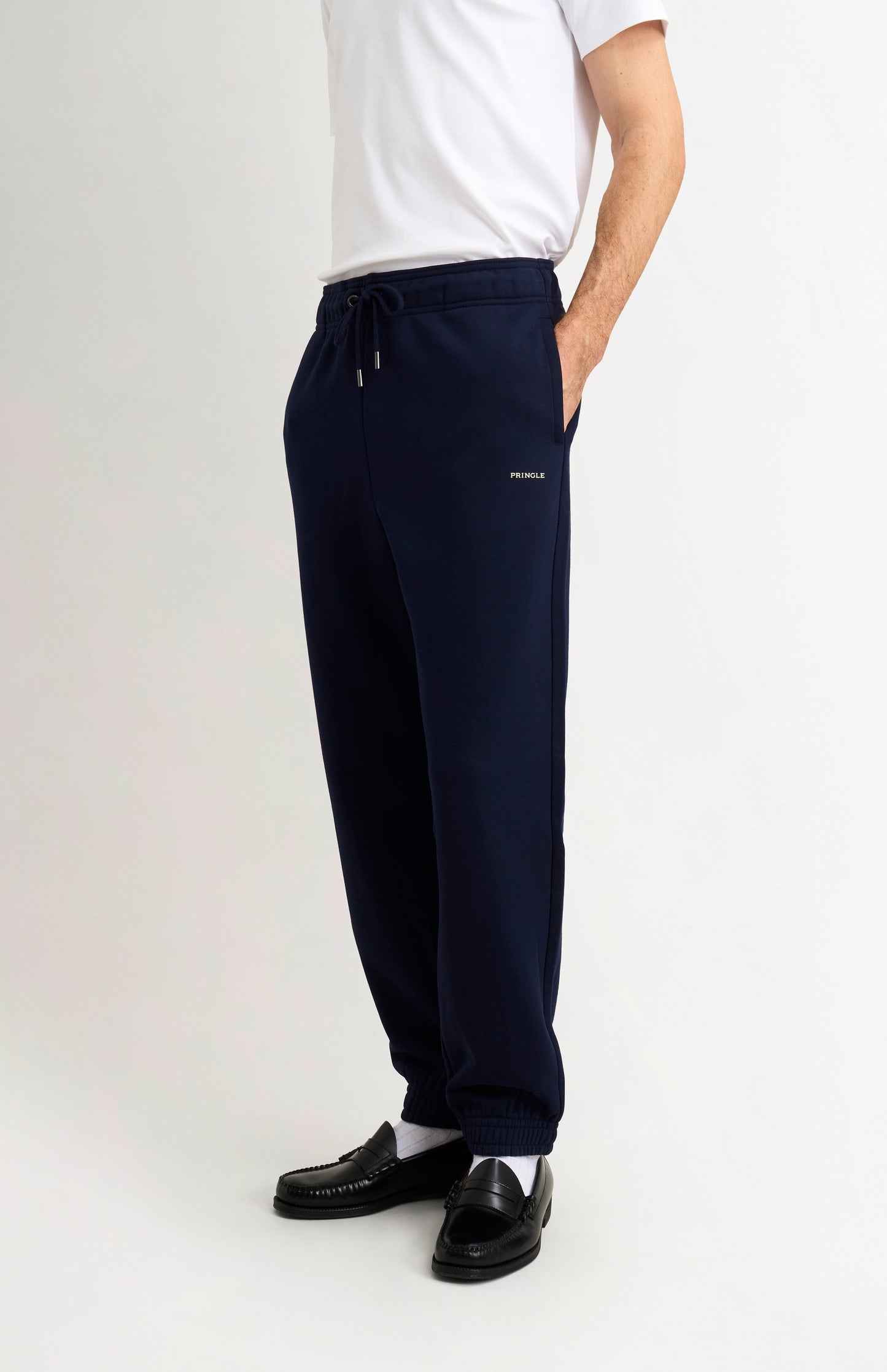 Pringle of Scotland Men's Track Pants In Navy Blue on model side view
