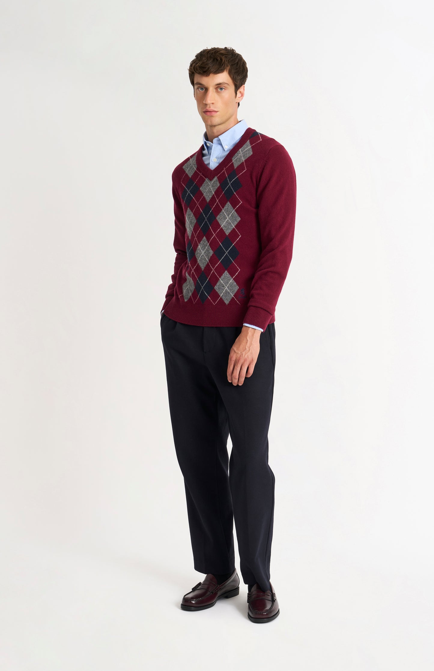Pringle Men’s Lambswool Argyle V-Neck Jumper in Burgundy, Navy & Grey on model full length