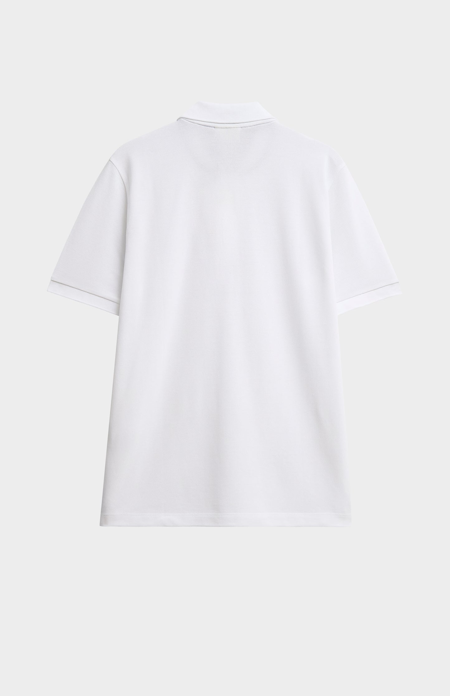 White polo shirt on a light gray background