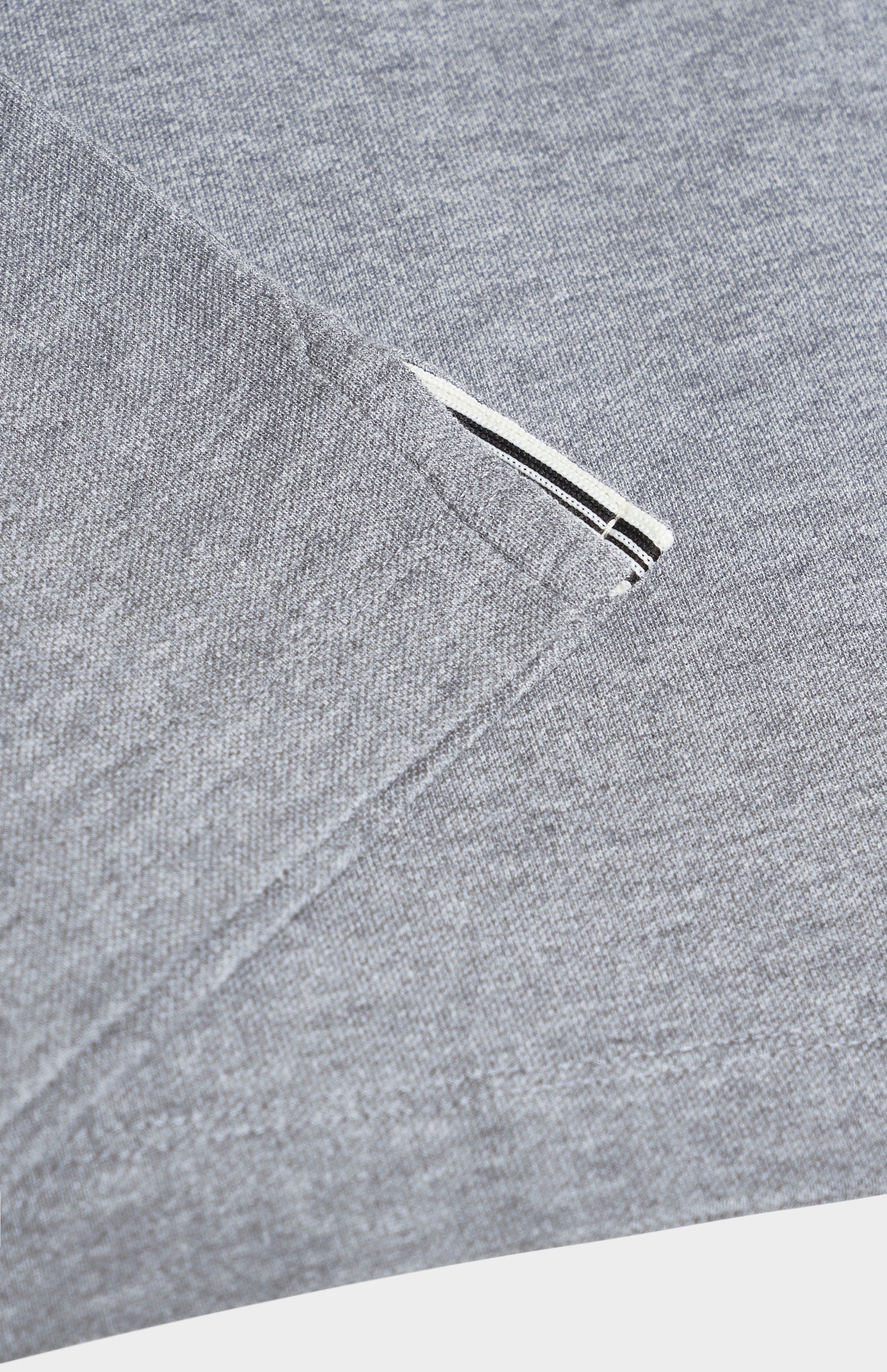 Close-up of a gray polo shirt on a white background