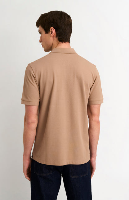 Man wearing a brown polo shirt on a white background