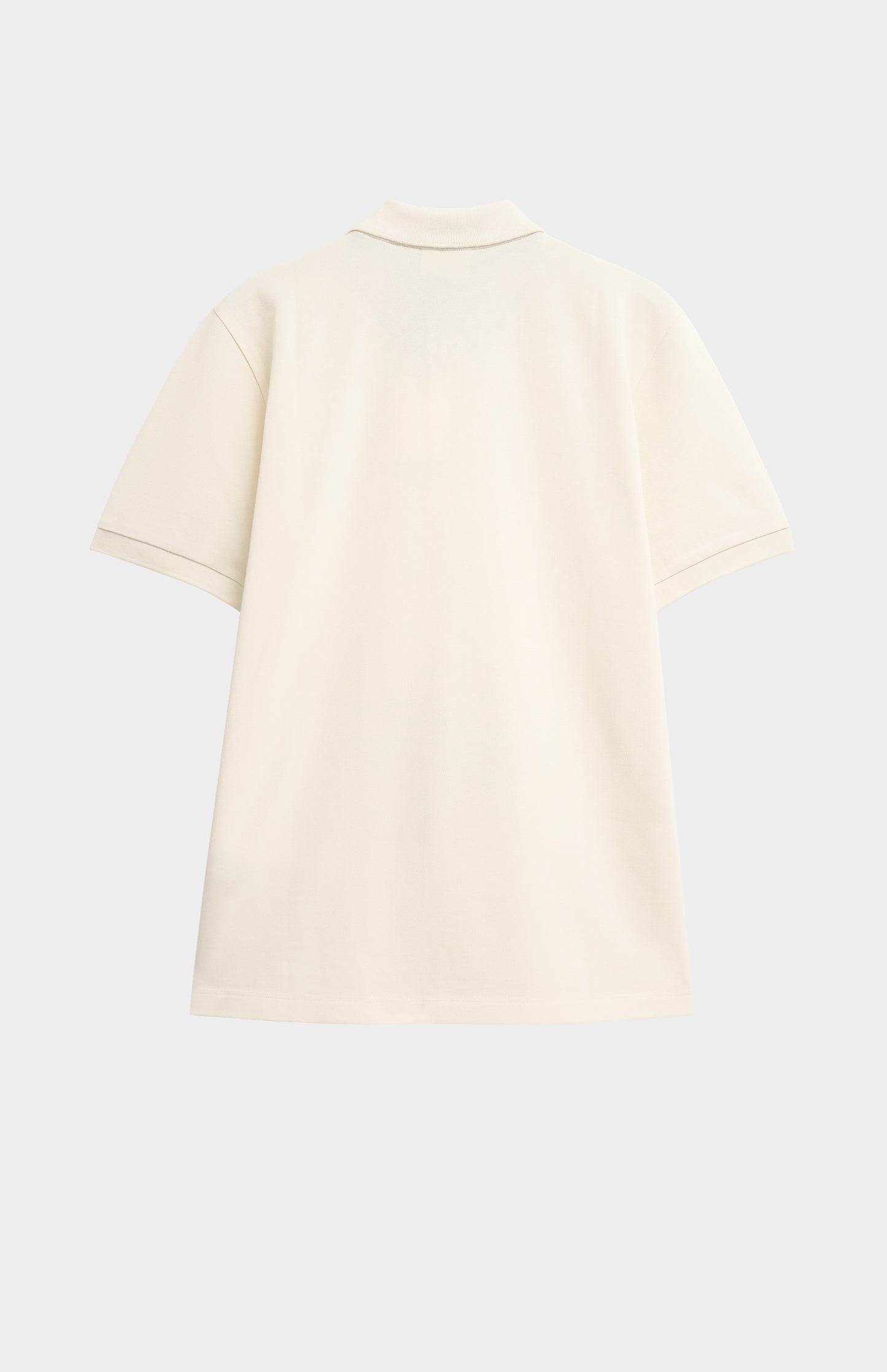 Beige polo shirt on a light gray background