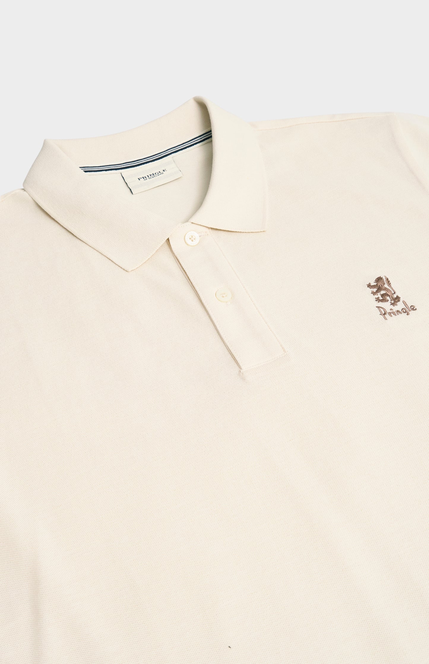 Beige polo shirt with a small logo on a white background