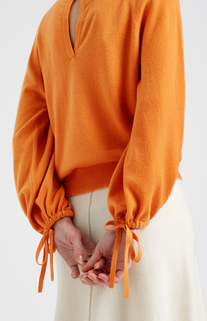Pringle of Scotland Lightweight Round Neck Cashmere Jumper in Orange showing tie gathering at cuff